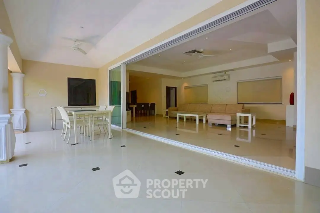 Spacious open living room with elegant dining area and modern decor.