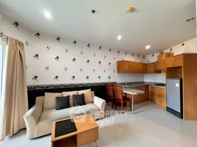 Spacious living room with open kitchen layout and modern decor