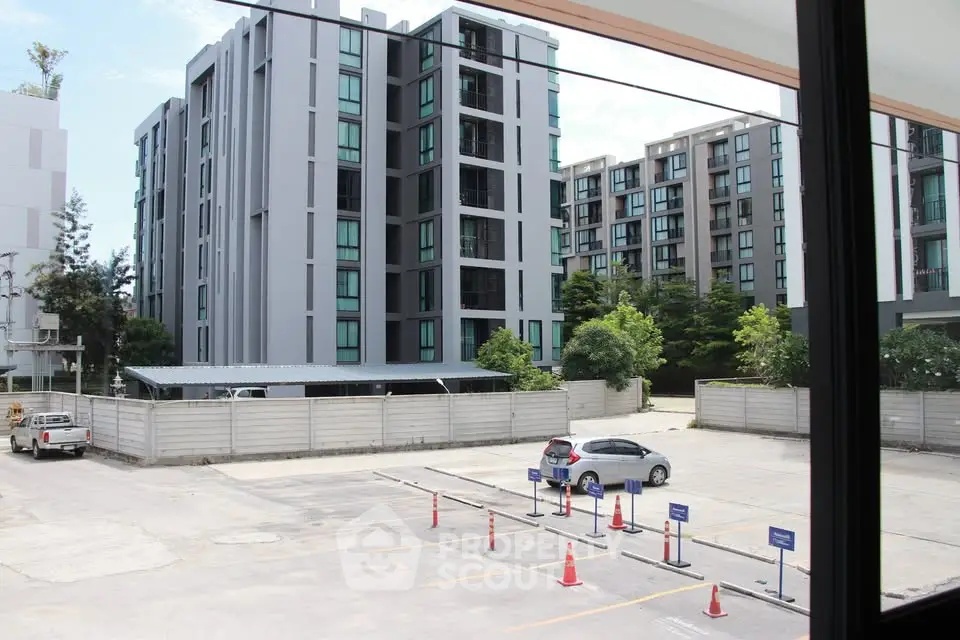 Modern apartment complex with parking area and urban surroundings