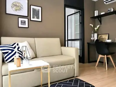 Modern living room with stylish decor and workspace in a cozy apartment.