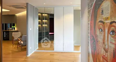 Modern living space with mirrored wardrobe and stylish decor