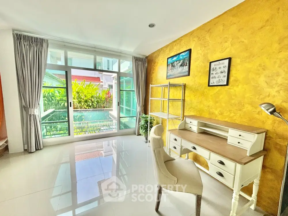 Bright study room with pool view and elegant desk setup