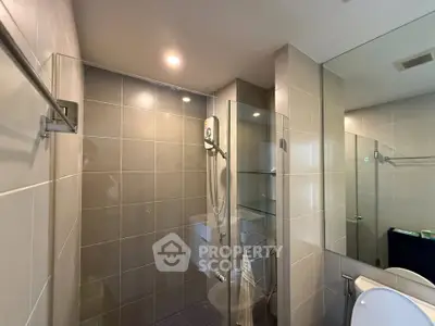 Modern bathroom with glass shower enclosure and sleek tile design