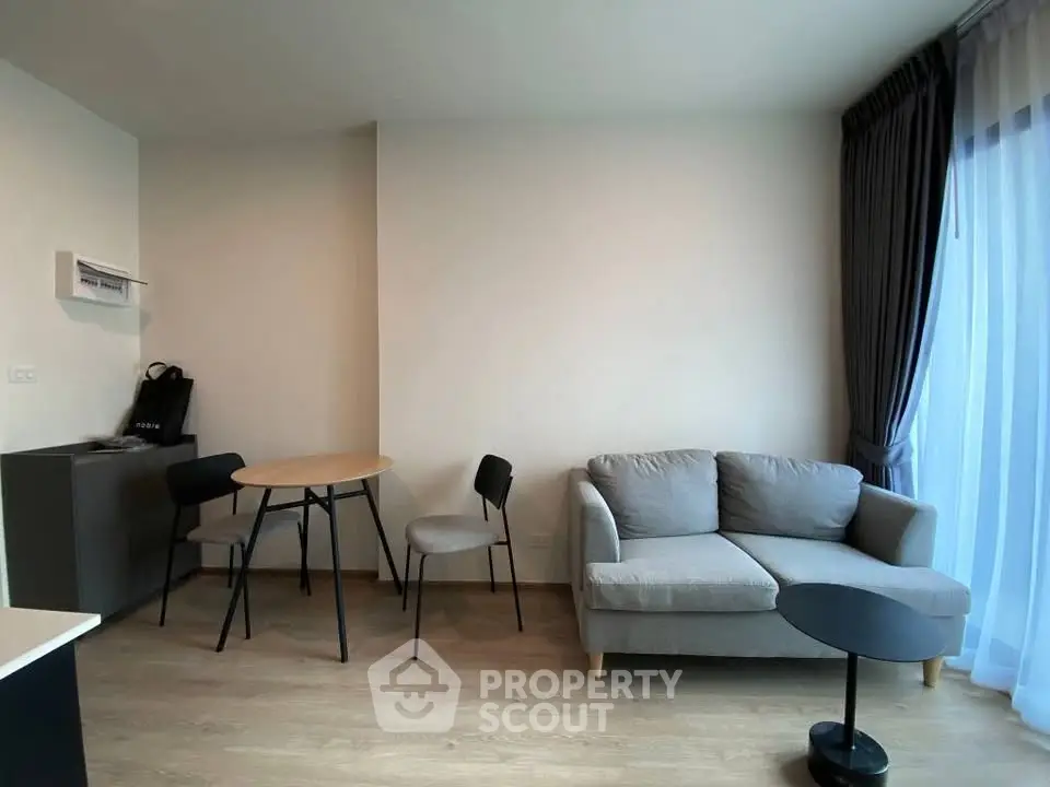 Modern living room with cozy sofa and dining area in stylish apartment.
