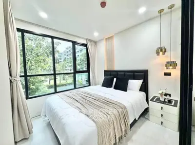 Modern bedroom with large windows and stylish decor in a luxury apartment.