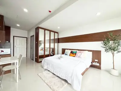 Spacious modern bedroom with elegant decor and ample natural light