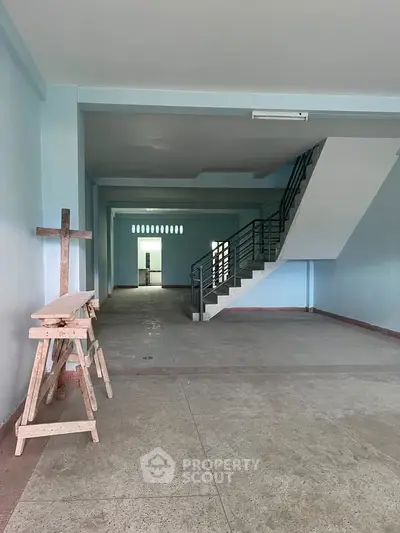 Spacious unfinished interior with staircase, ideal for customization in a new property development.