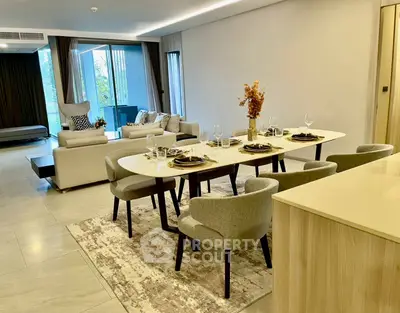 Luxurious open-plan living and dining area with elegant decor and large windows.