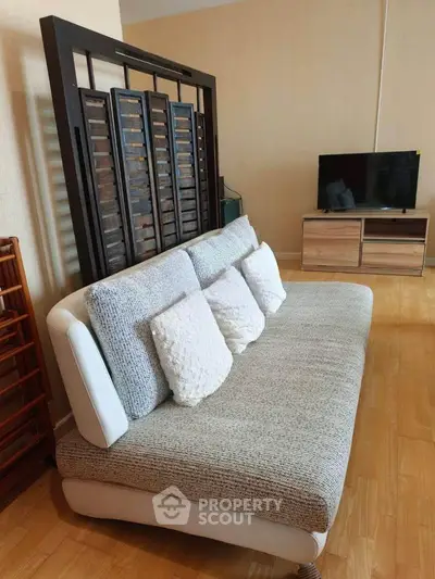 Modern living room with stylish sofa and TV stand on wooden flooring