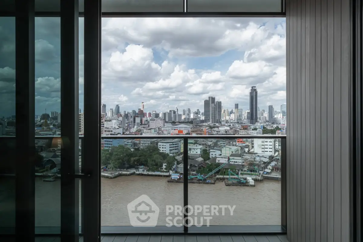 Stunning cityscape view from modern balcony overlooking river and skyline.