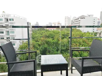 Charming balcony with city view, perfect for relaxation and enjoying urban greenery.