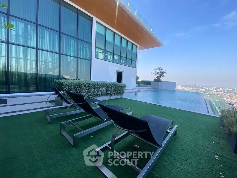 Luxurious rooftop pool with stunning city view and modern lounge chairs