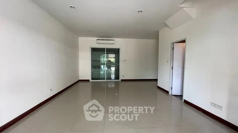 Spacious unfurnished room with tiled flooring and air conditioning, ideal for customization.