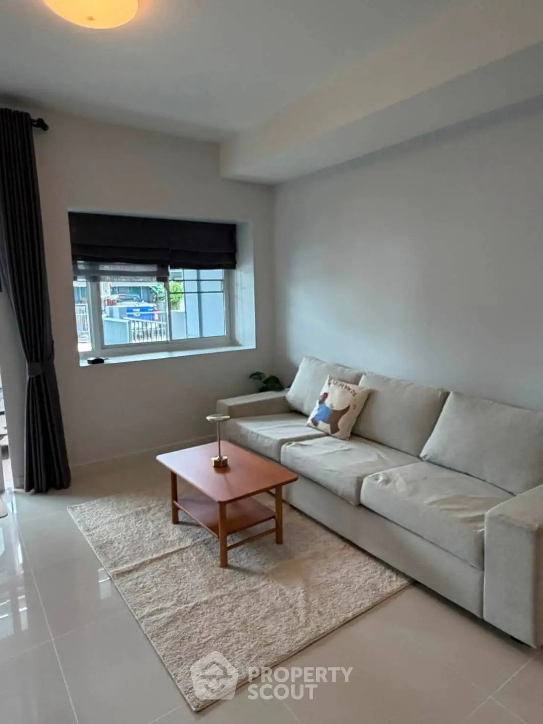 Modern living room with sleek sofa and stylish decor in a bright, airy space.