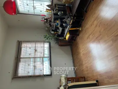 Charming living room with wooden flooring and natural light, perfect for cozy gatherings.