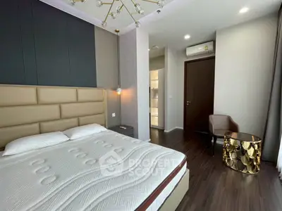 Modern bedroom with stylish decor and elegant lighting in a luxury apartment.