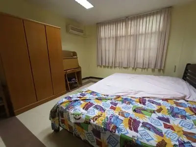 Cozy bedroom with colorful bedding and ample natural light