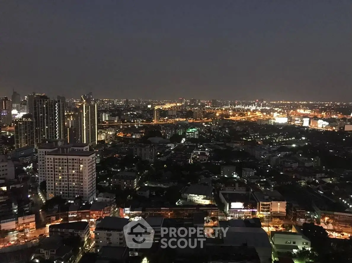 Stunning cityscape view from high-rise building at night, showcasing vibrant urban lights.