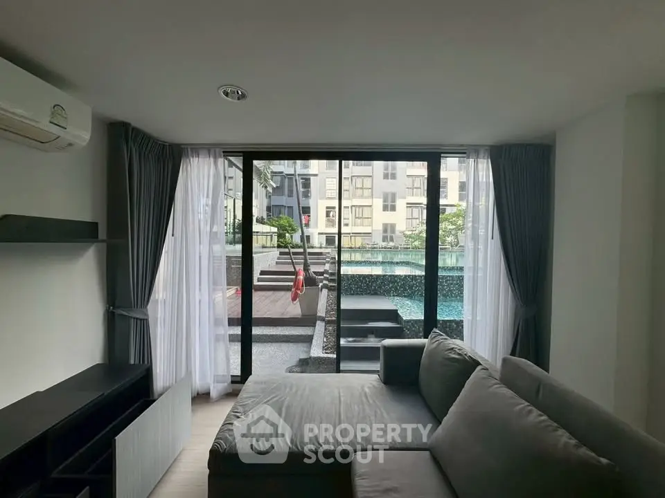 Modern living room with pool view and stylish sofa in luxury apartment