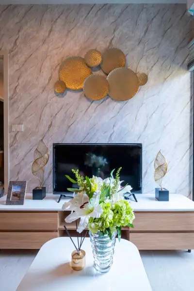 Stylish living room with modern decor and elegant wall art, featuring a sleek TV setup.