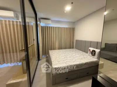 Modern bedroom with glass partition and stylish decor in a contemporary apartment.