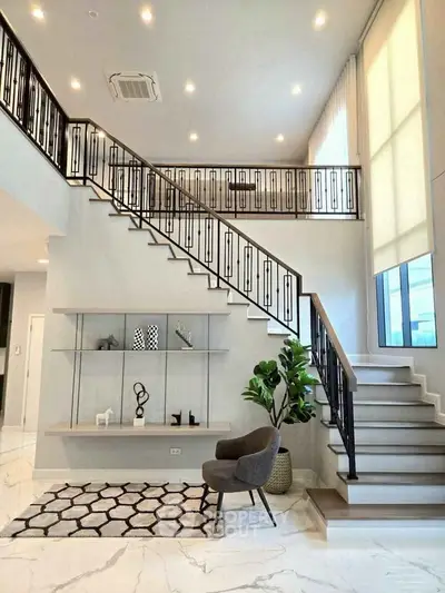 Luxurious modern living room with elegant staircase and stylish decor