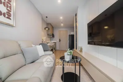 Modern living room with sleek furniture and open kitchen layout in a stylish apartment.