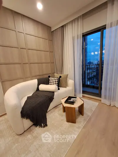 Stylish living room with cozy sofa and balcony view in modern apartment