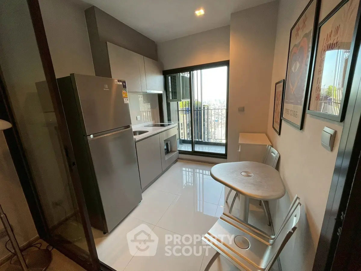 Modern kitchen with balcony view, sleek appliances, and stylish decor