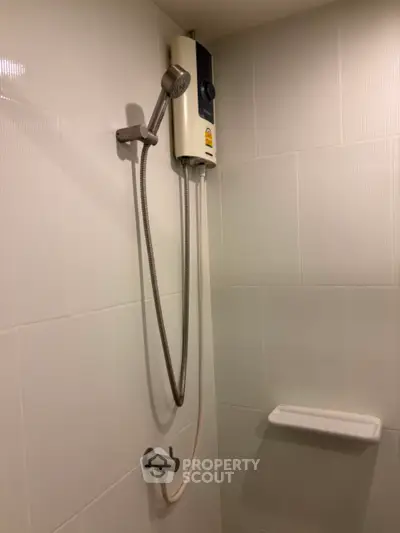 Modern bathroom with sleek shower and white tiled walls