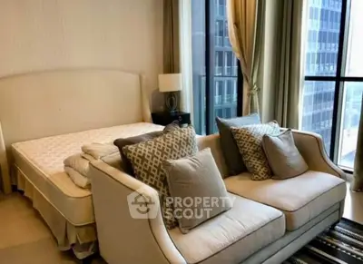 Luxurious bedroom with elegant seating and city view