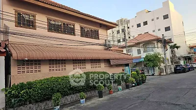 Charming residential building with lush greenery and traditional architecture in a serene neighborhood.