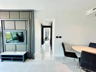 Modern living room with sleek TV setup and elegant dining area