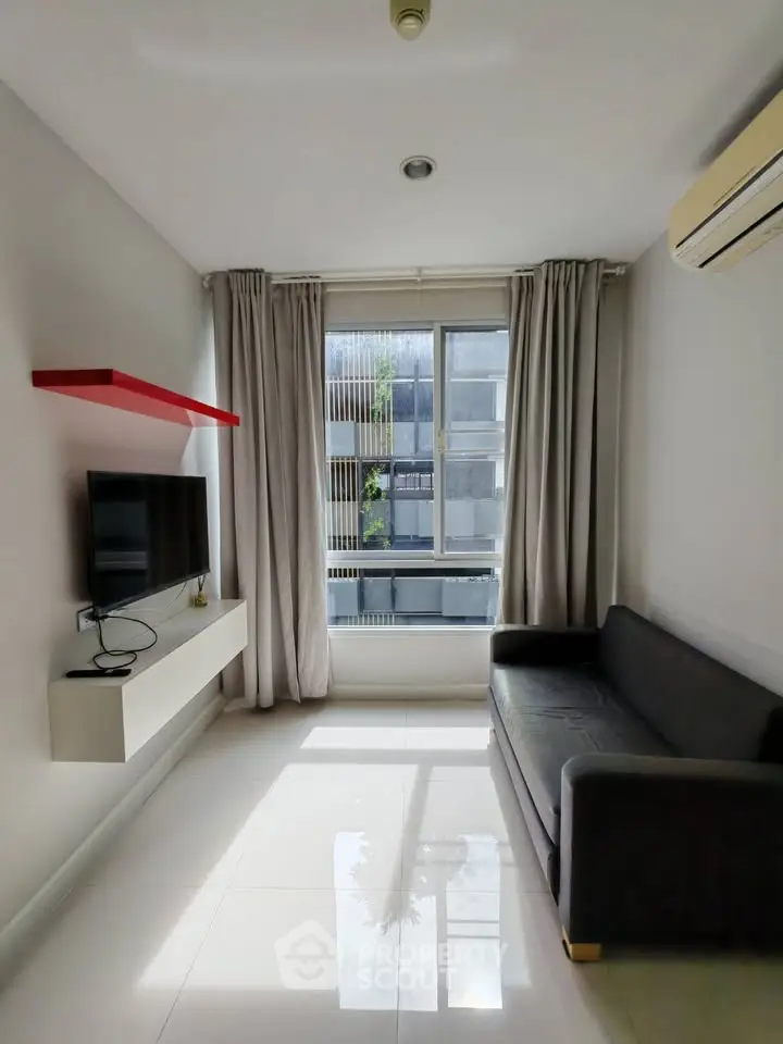 Modern living room with sleek design, featuring a wall-mounted TV, cozy sofa, and large window for natural light.