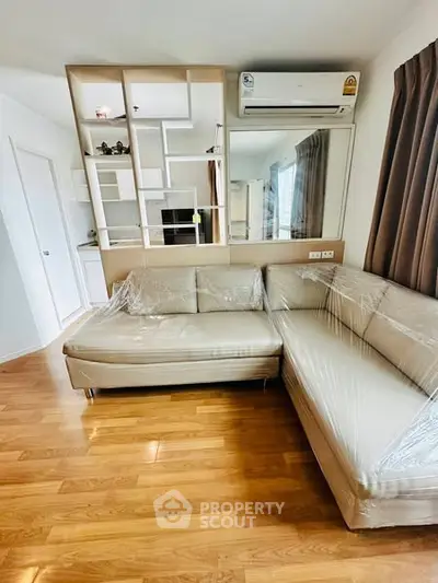 Modern living room with stylish sectional sofa and wooden flooring