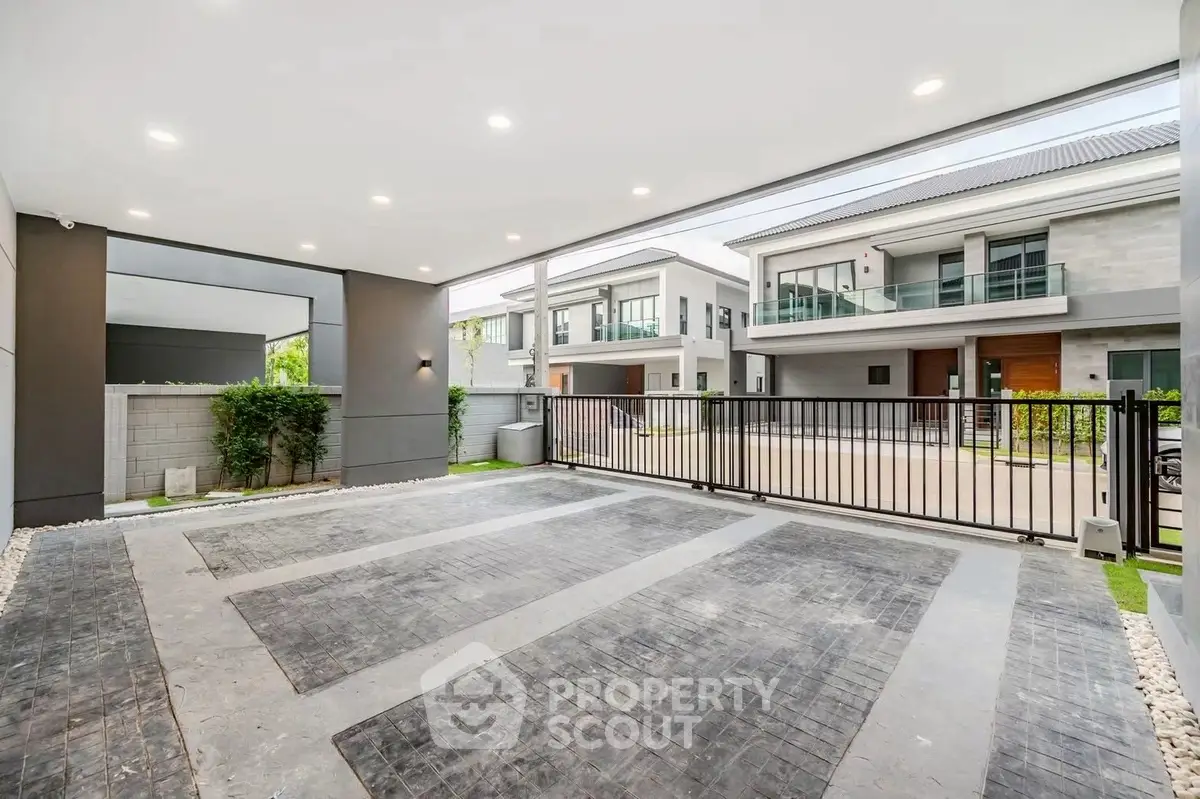 Spacious modern parking area in a luxury residential complex with sleek design and ample lighting.