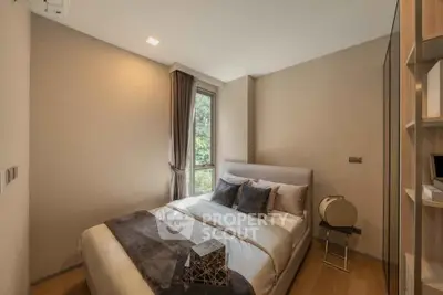Cozy modern bedroom with large window and stylish decor in a contemporary apartment.