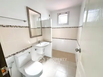 Modern bathroom with sleek fixtures and neutral tiles