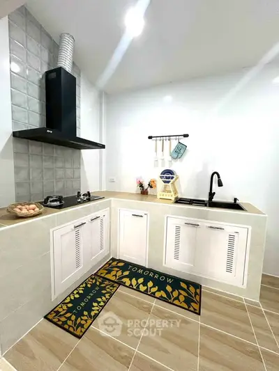 Modern kitchen with sleek design, featuring gas stove and stylish cabinetry.