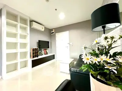 Modern living room with sleek design, built-in shelves, and stylish decor.