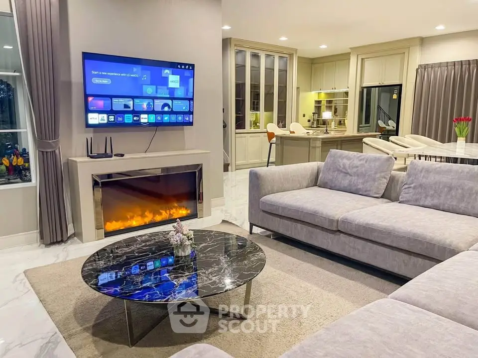 Luxurious living room with modern fireplace and open kitchen layout