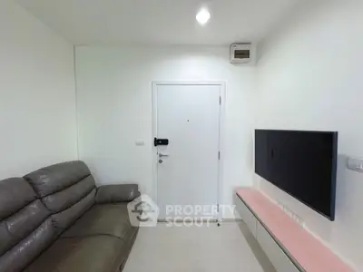 Modern living room with sleek leather sofa and wall-mounted TV