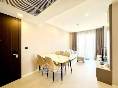 Modern living room with elegant dining area and natural light