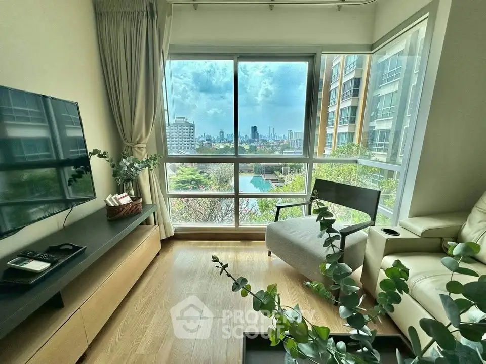 Modern living room with large windows offering stunning city view and natural light.