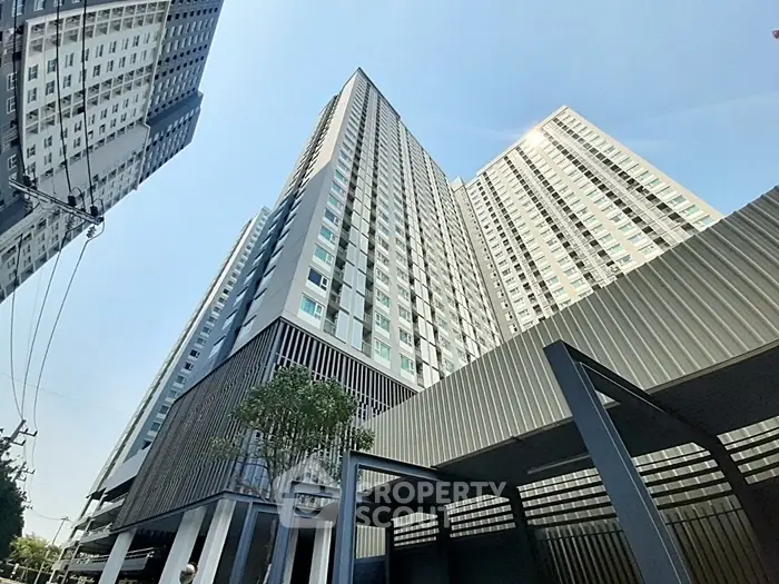 Modern high-rise residential building with sleek architectural design and expansive windows.