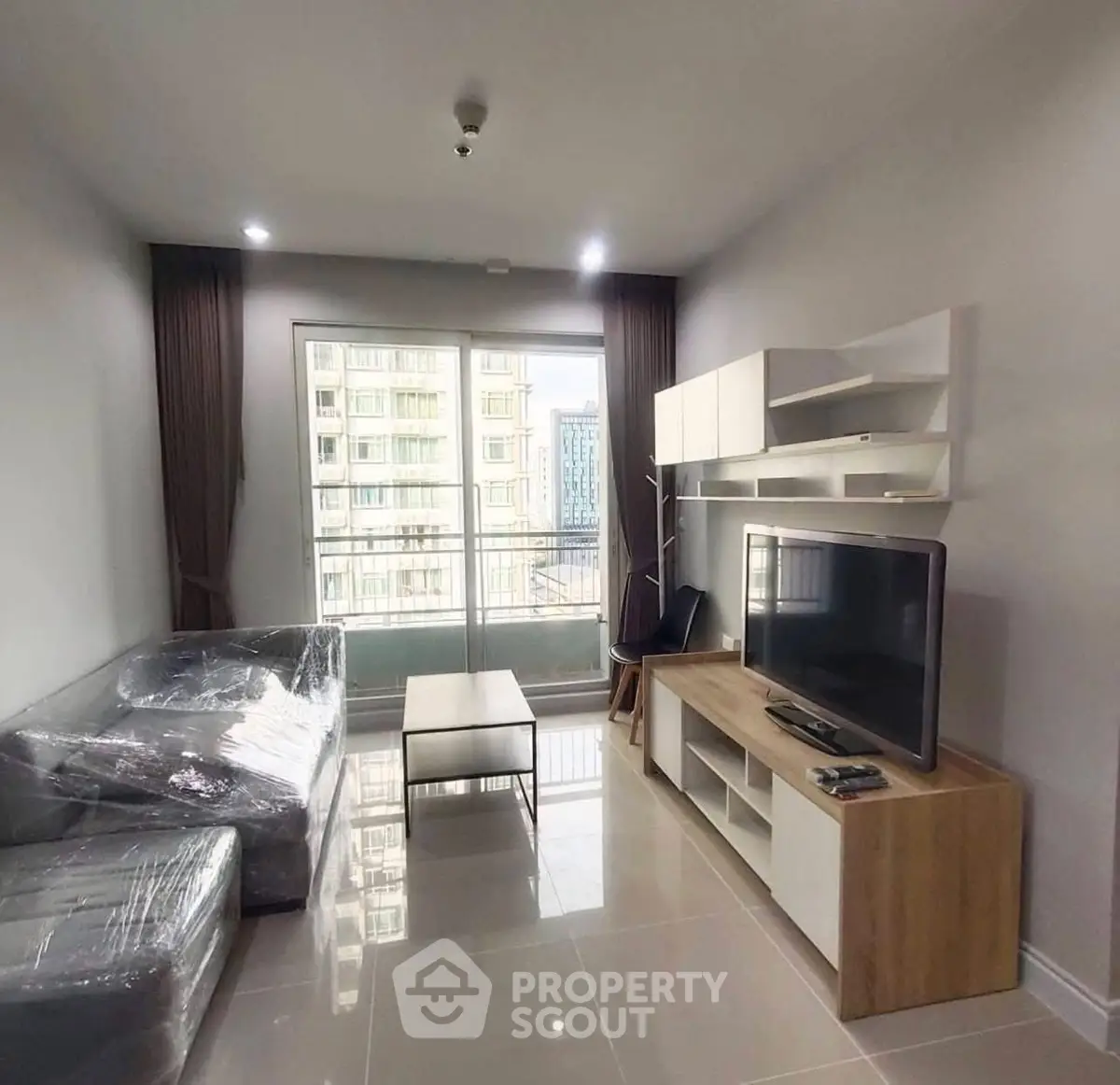 Modern living room with sleek furniture and large window view