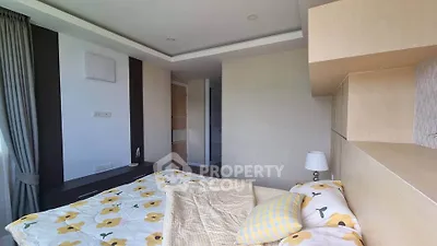 Cozy bedroom with floral bedding and modern design, featuring ample natural light and stylish decor.