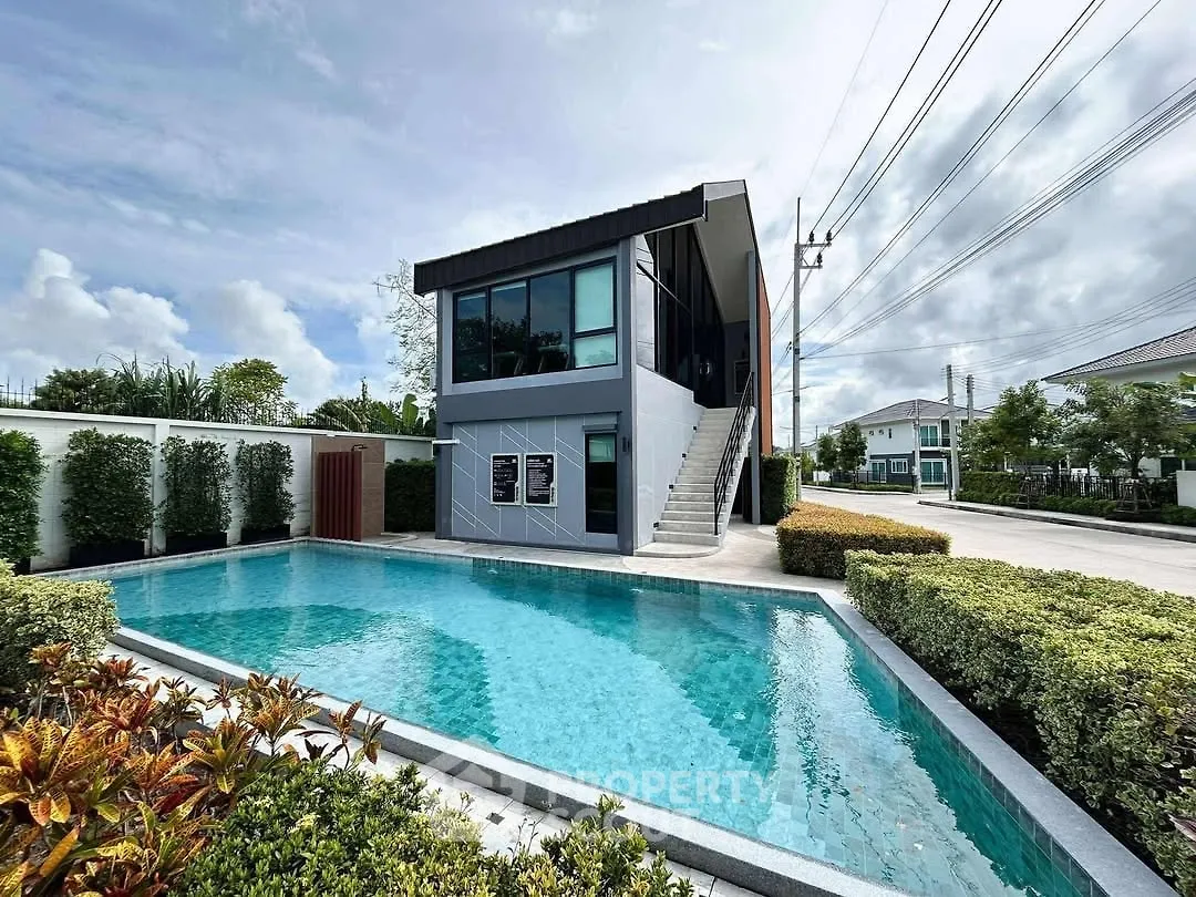 Modern two-story building with pool and lush landscaping