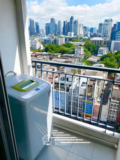 Stunning city view from balcony with washing machine, perfect urban living convenience.