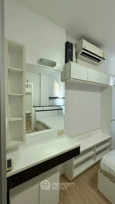 Modern bedroom with built-in storage and air conditioning unit
